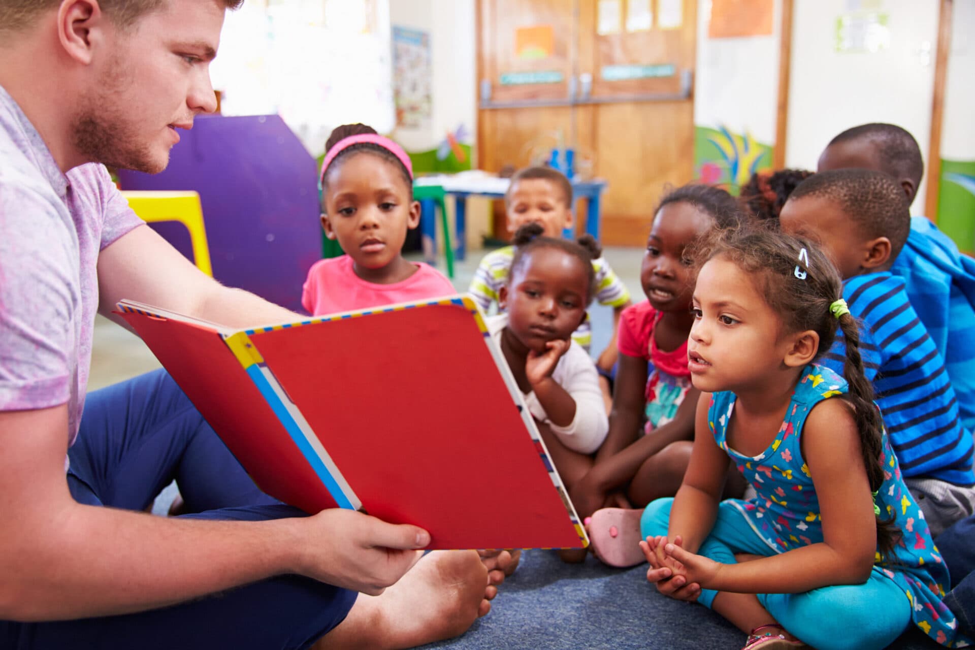 A teacher playing with children at Creation Kingdom Frankfort Center 1