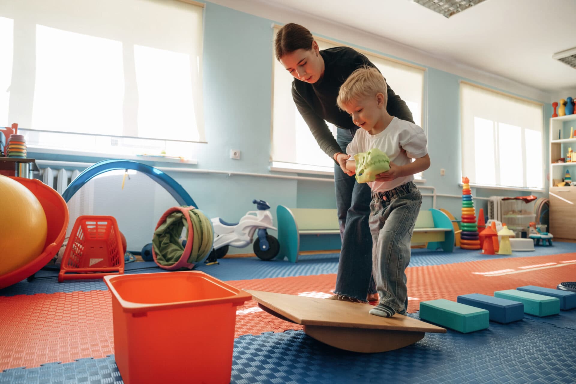 A teacher playing with children at Creation Kingdom McConnells Trace